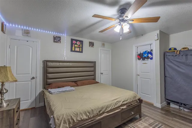 a bed room with a bed and a ceiling fan