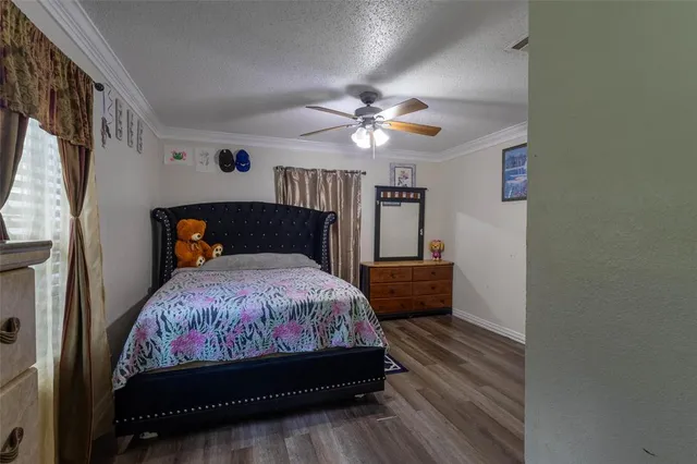 a bedroom with a bed window and a chandelier