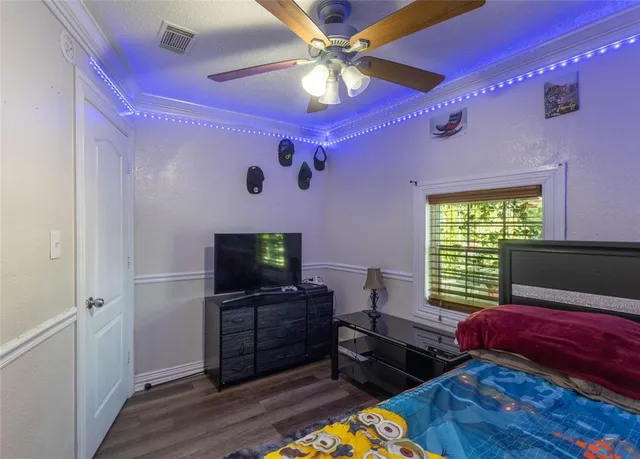 a bedroom with furniture and a flat screen tv