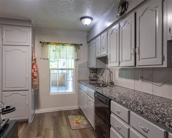 a kitchen with stainless steel appliances granite countertop a refrigerator sink and cabinets