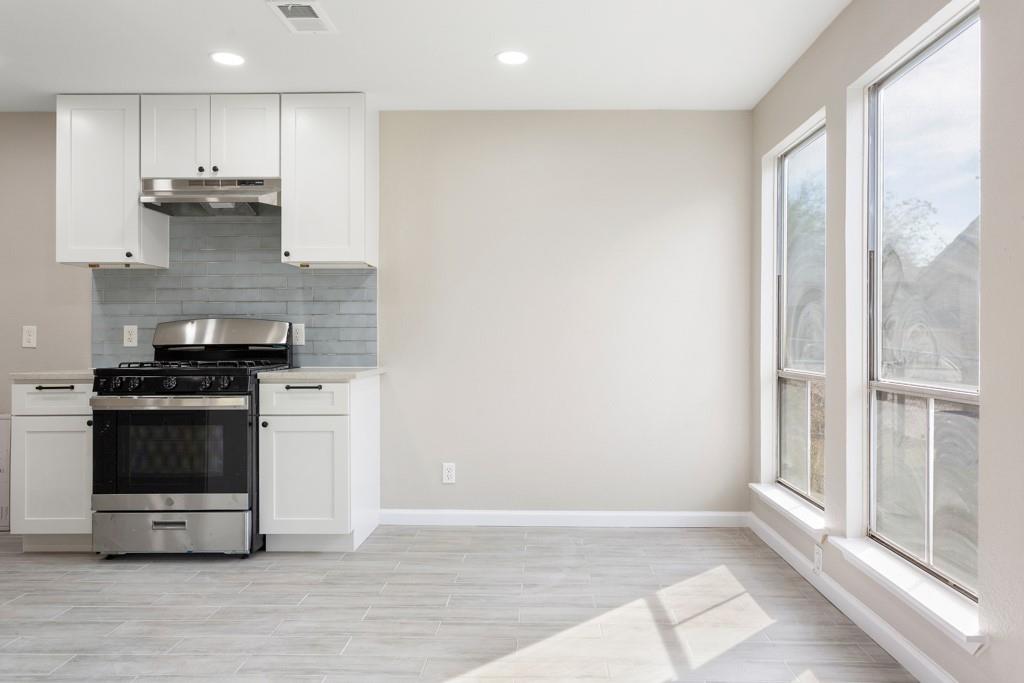 9604 Crown Ridge Road Austin, TX 78753 - Photo 12 of 24 Sun-filled kitchen features stainless steel appliances and light-toned flooring.