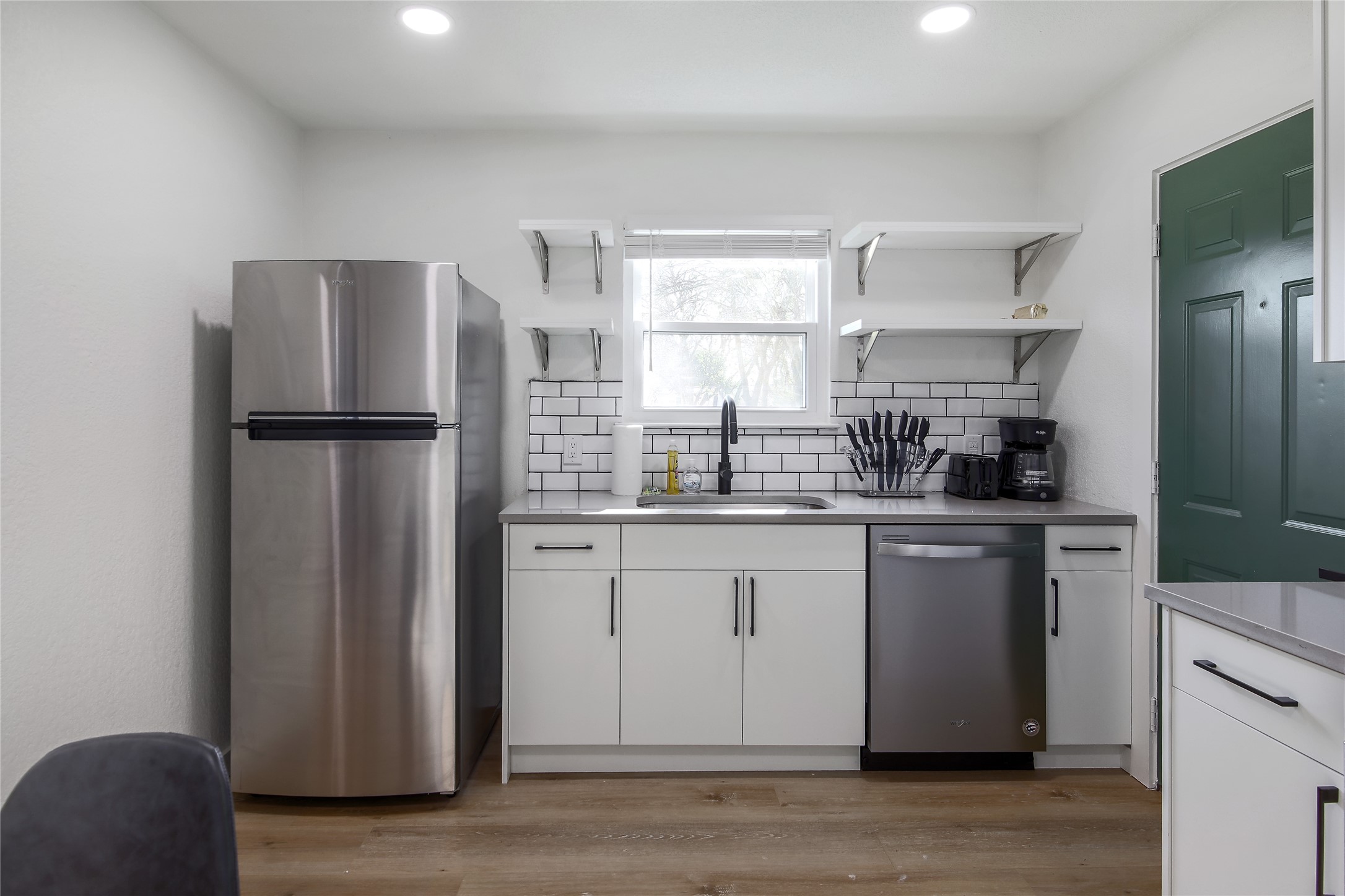 10509 Macmora Road, Unit B Austin, TX 78758 - Photo 7 of 19 a kitchen with stainless steel appliances a refrigerator sink and cabinets