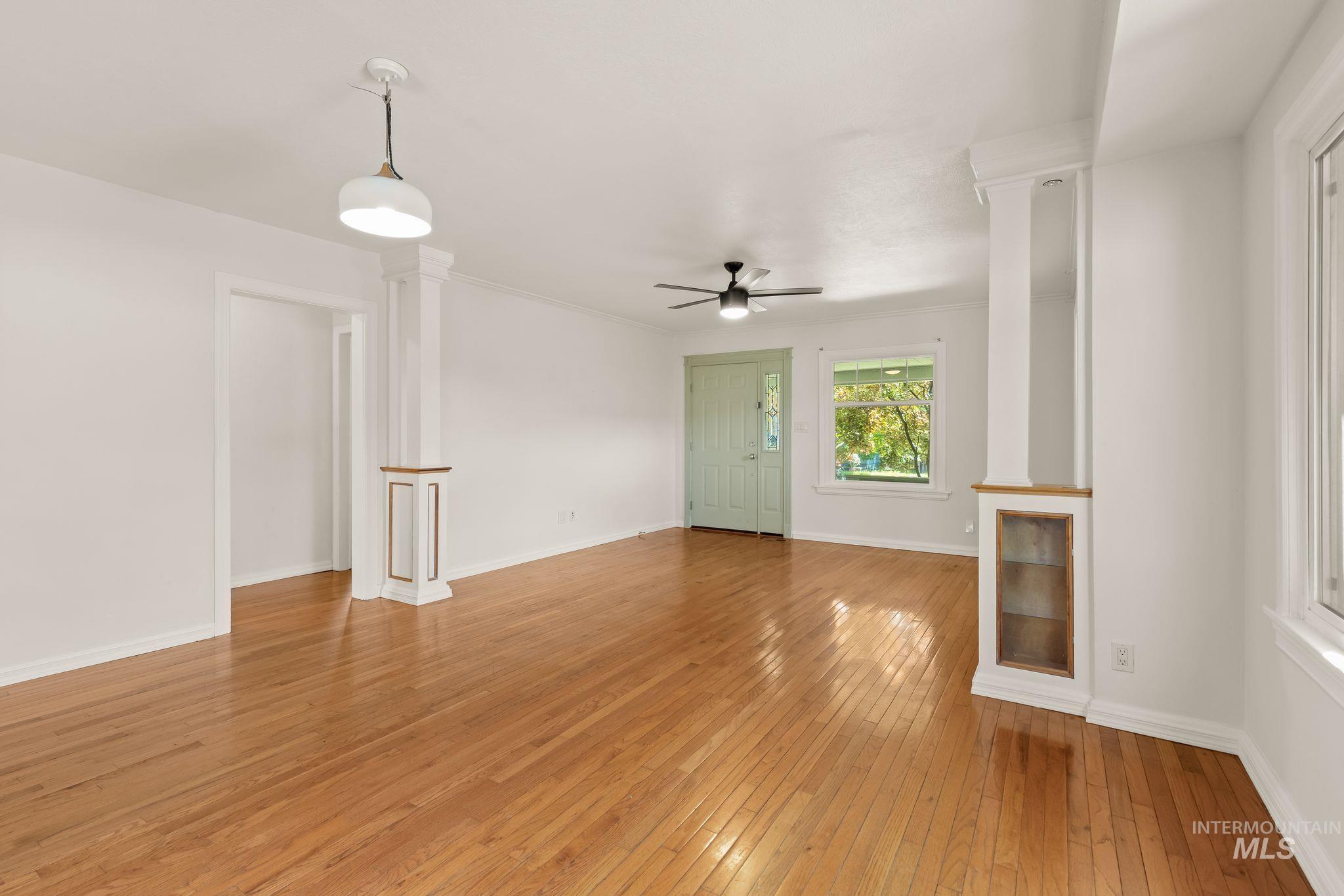 928 3rd Street Clarkston, WA 99403 - Photo 7 of 44 Spacious interior featuring wood-finish flooring, a contemporary ceiling fan, and prominent white trim