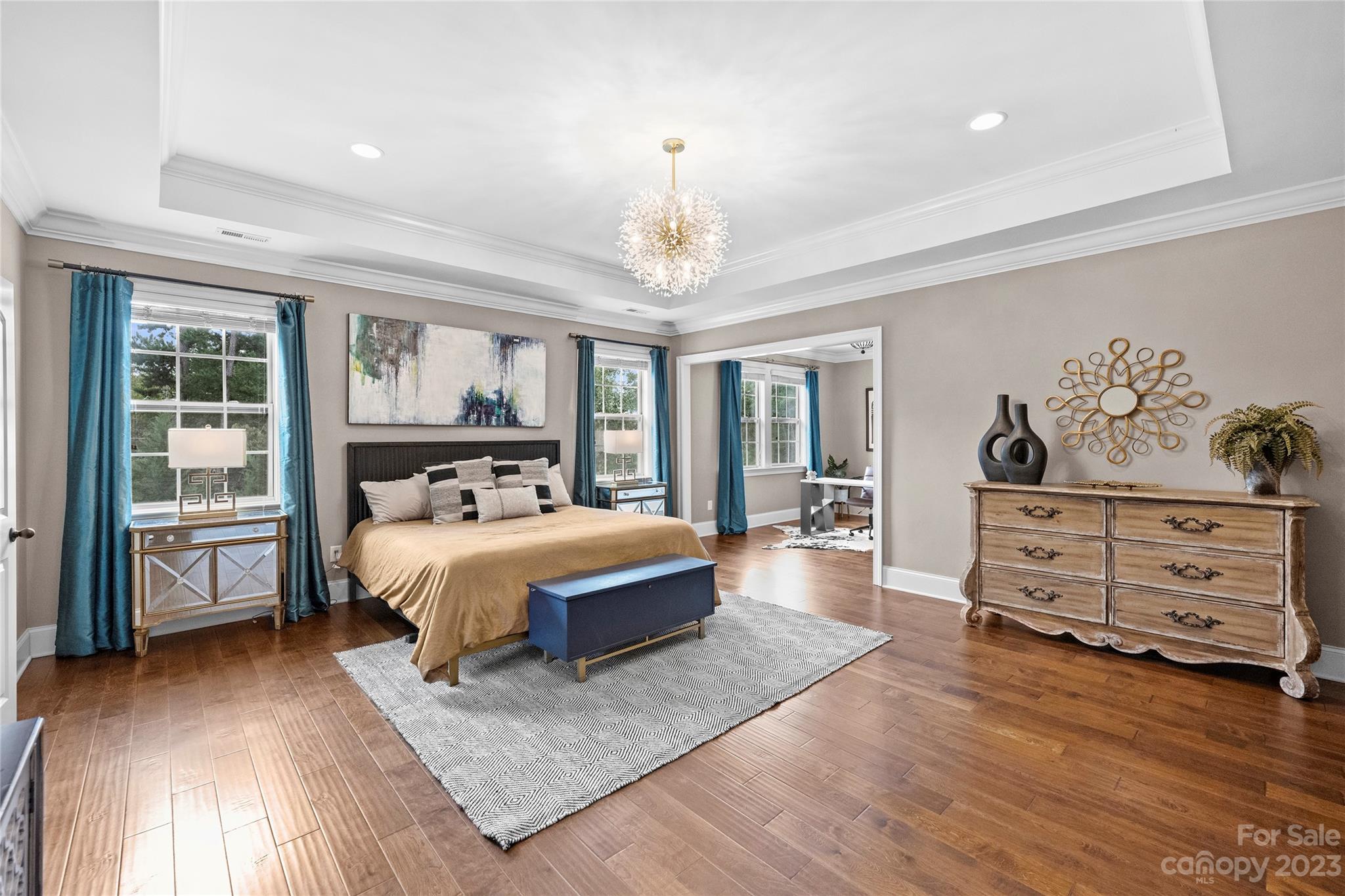 658 Zinnia Way Tega Cay, SC 29708 - Photo 17 of 32 a spacious bedroom with a large bed and a window