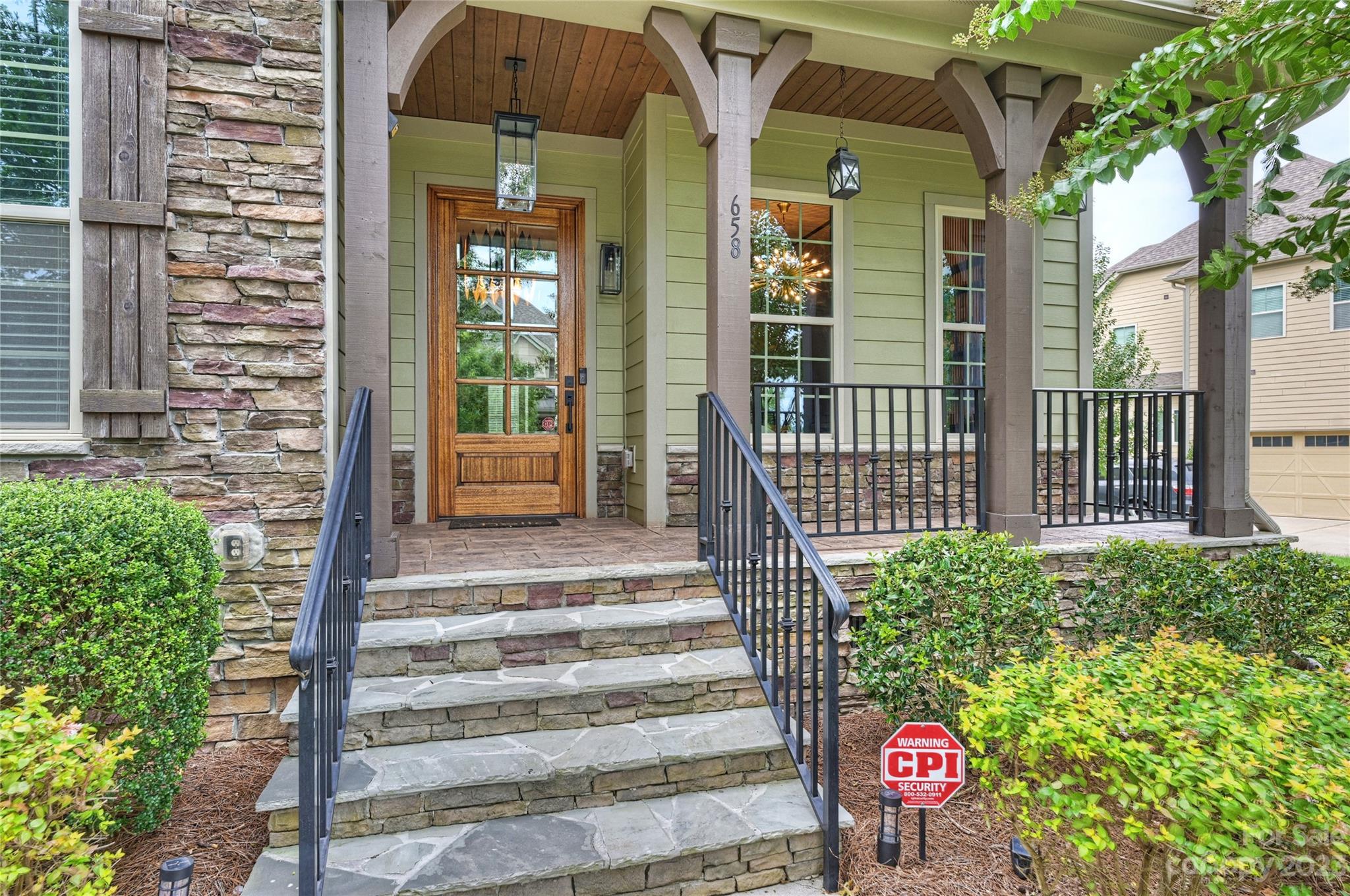 658 Zinnia Way Tega Cay, SC 29708 - Photo 2 of 32 a front view of a house with a tree