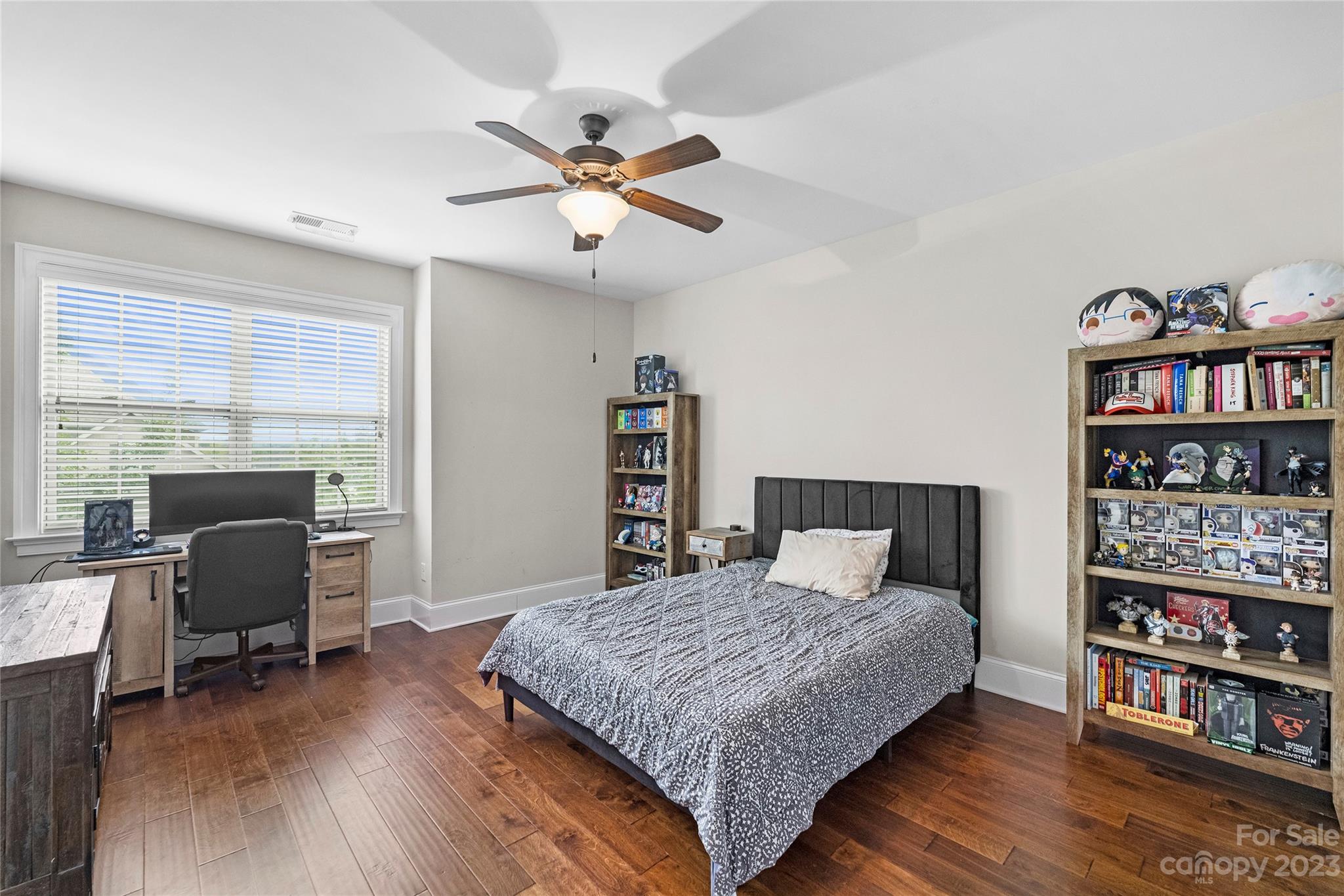 658 Zinnia Way Tega Cay, SC 29708 - Photo 26 of 32 a bedroom with a bed and a bookshelf