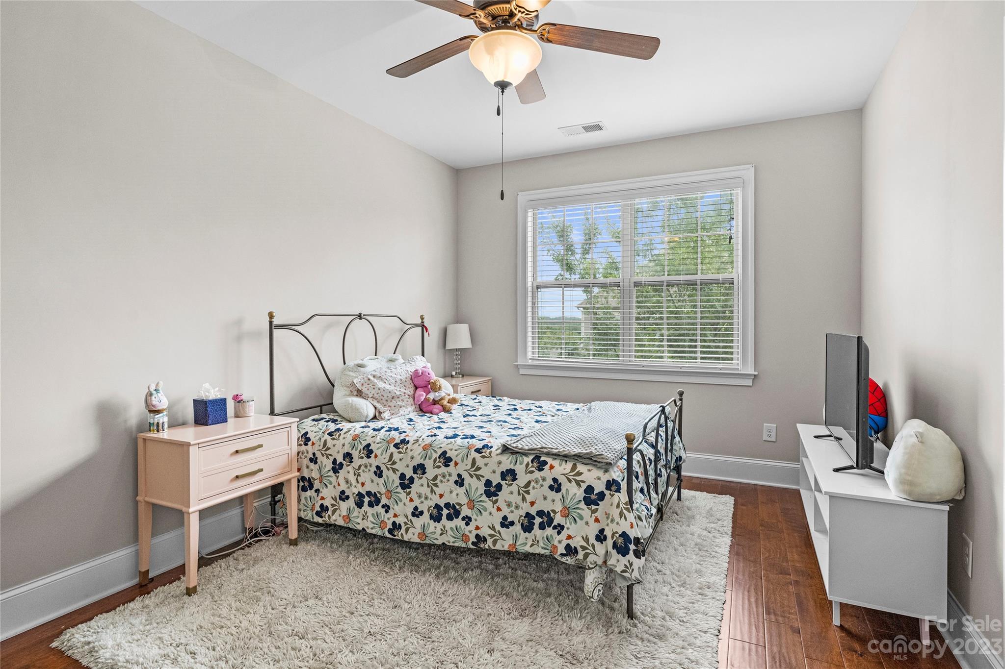 658 Zinnia Way Tega Cay, SC 29708 - Photo 27 of 32 a bedroom with a bed and a chandelier