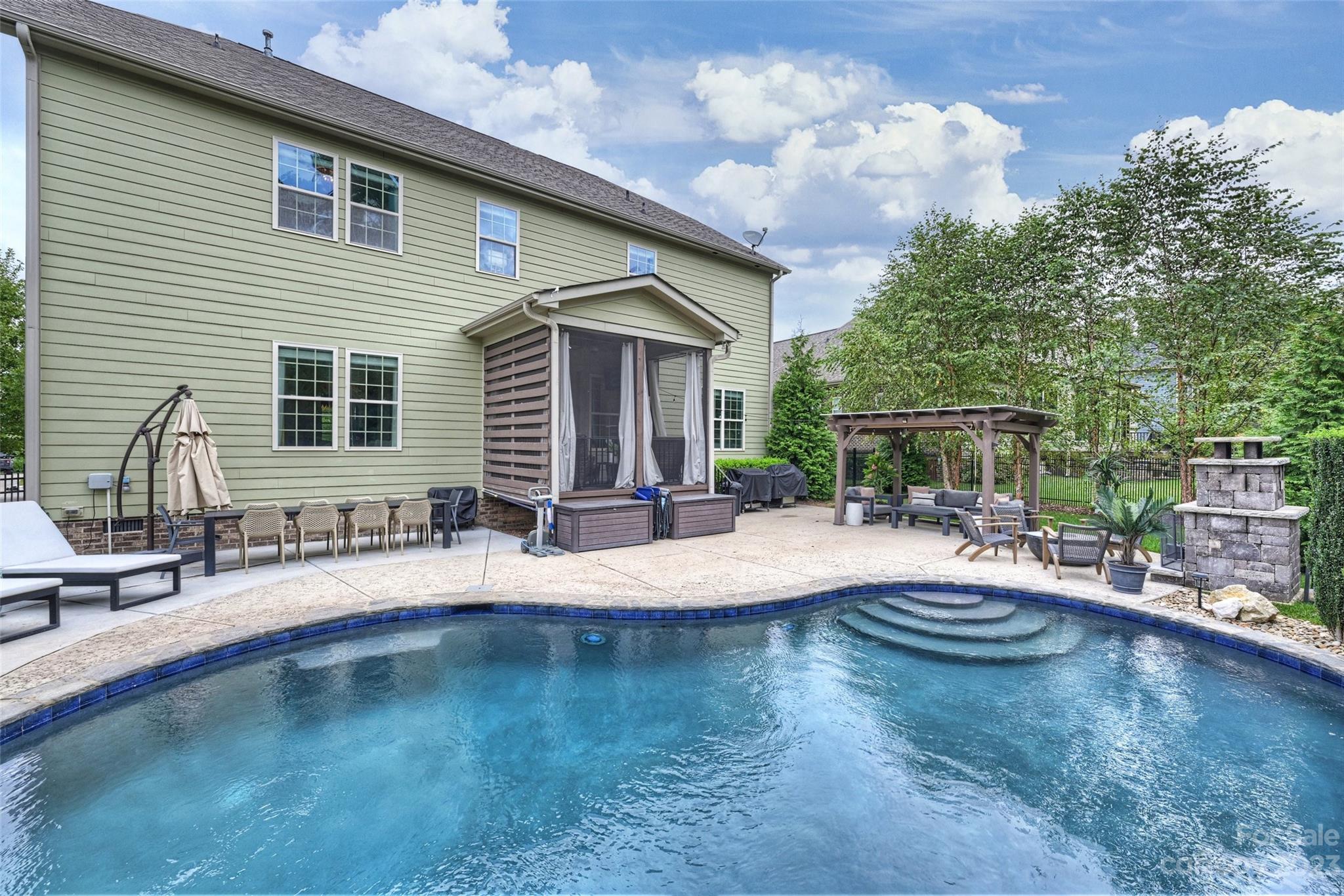 658 Zinnia Way Tega Cay, SC 29708 - Photo 3 of 32 a view of a house with swimming pool and sitting area