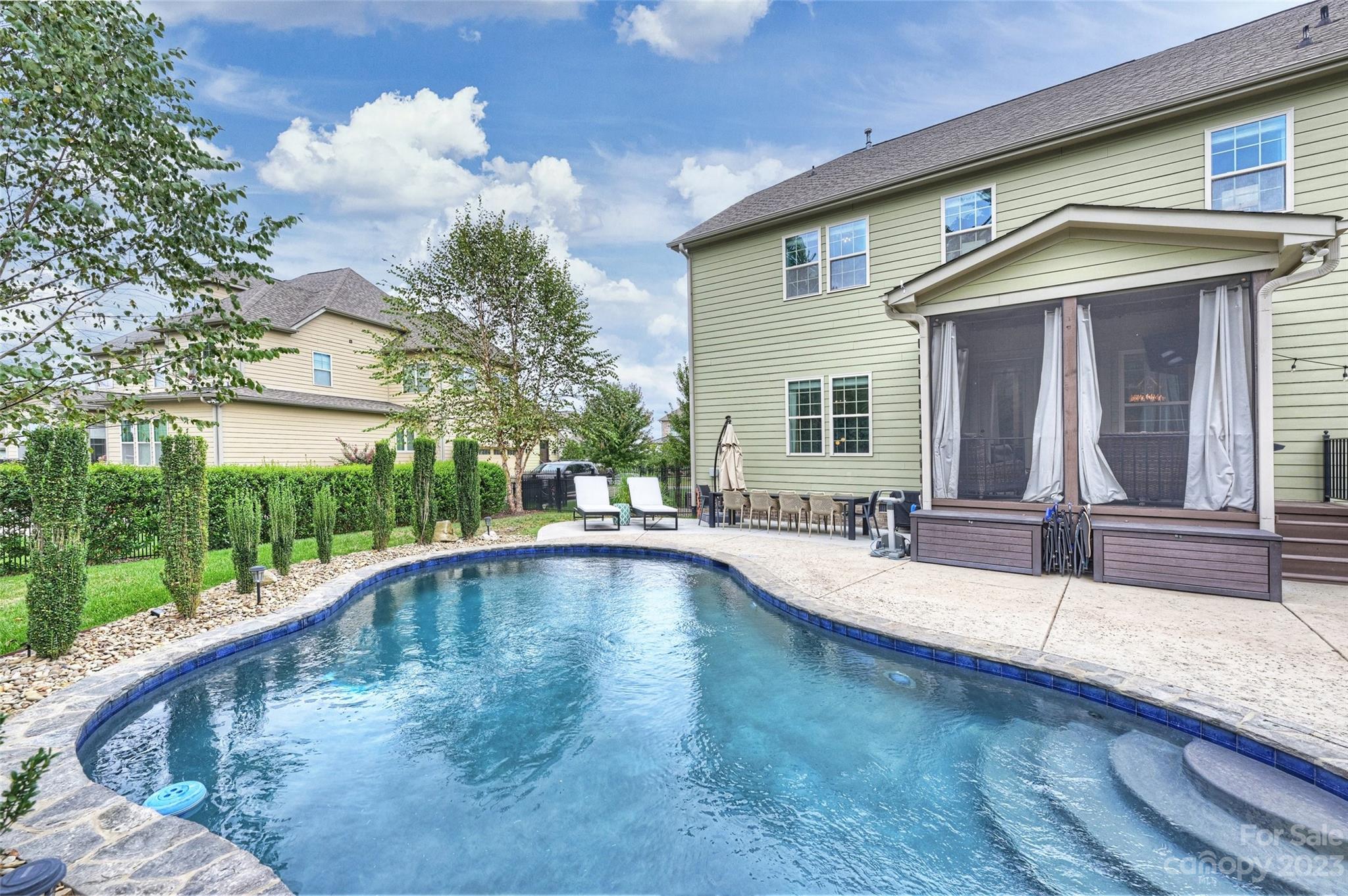 658 Zinnia Way Tega Cay, SC 29708 - Photo 32 of 32 a view of a house with swimming pool and a porch