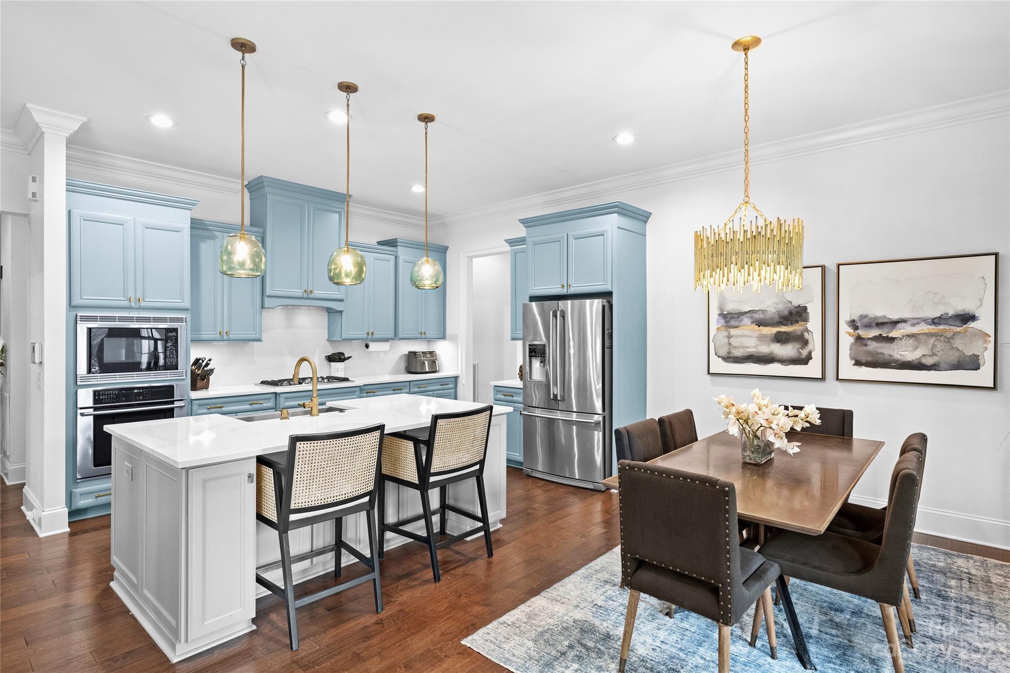 658 Zinnia Way Tega Cay, SC 29708 - Photo 9 of 32 a view of a dining room and a kitchen with a chandelier