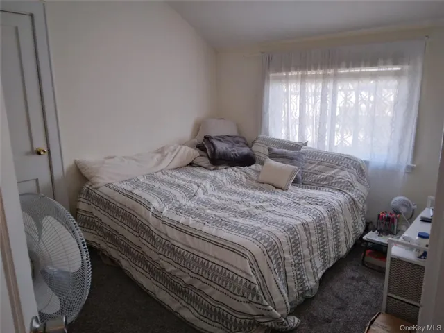 a bedroom with bed and window