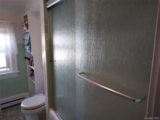 a bathroom with a toilet and a shower