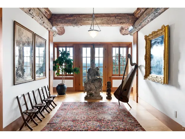 a view of a porch with furniture and floor to ceiling window