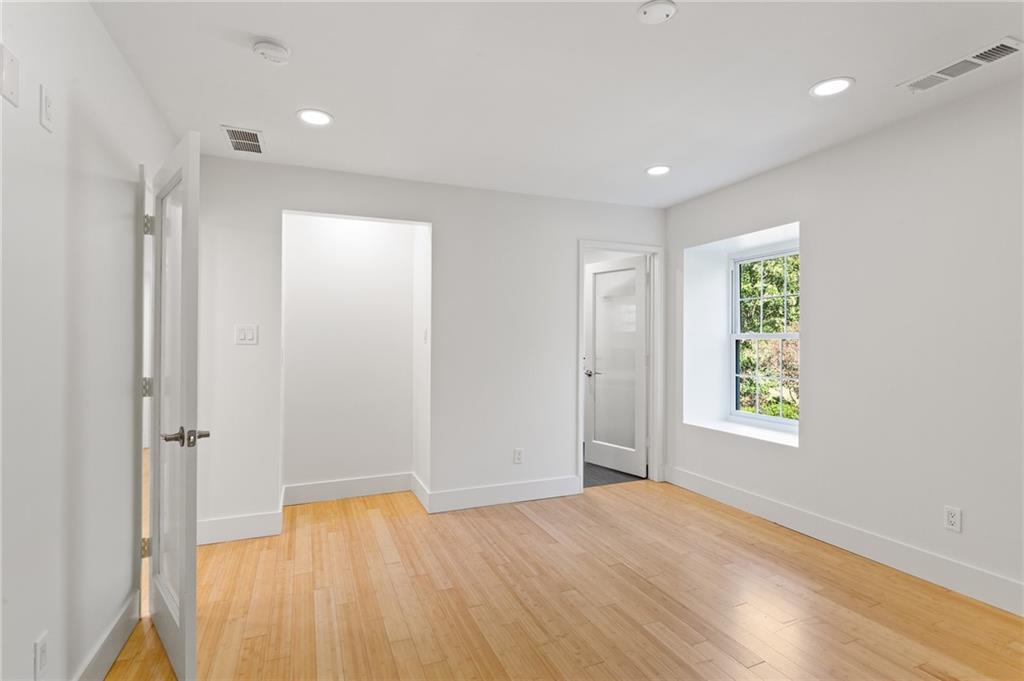 1261 Lavista Road Northeast, Unit C3 Atlanta, GA 30324 - Photo 11 of 34 a view of an empty room with wooden floor and a window