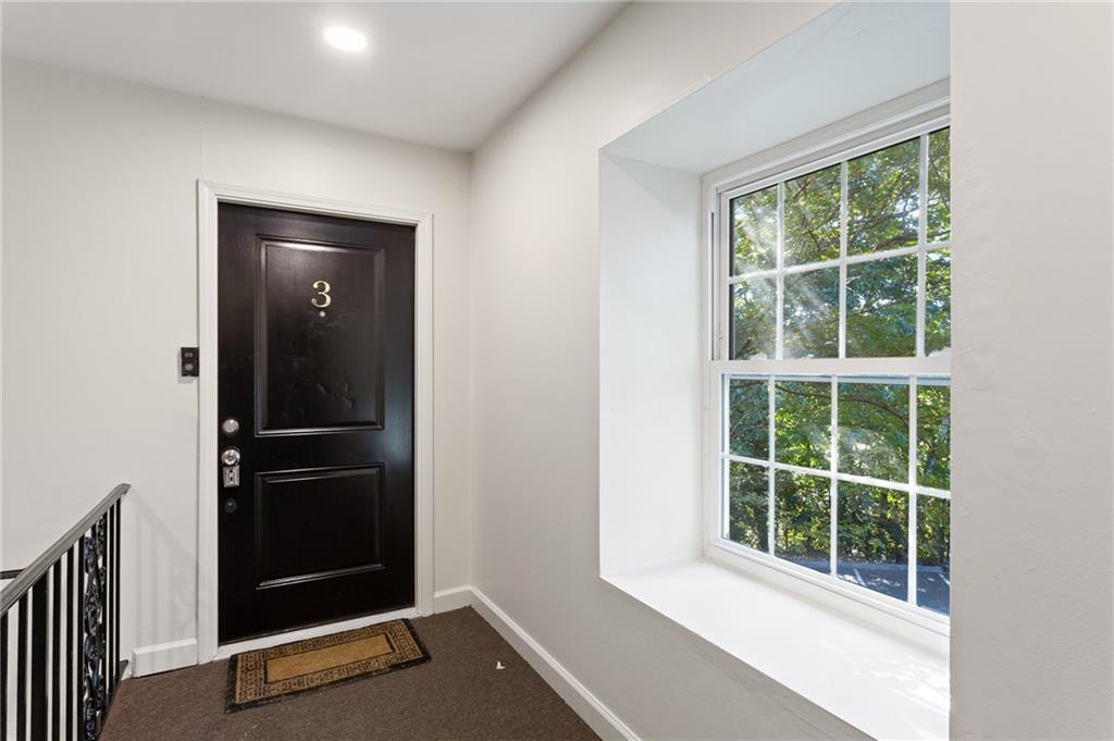 1261 Lavista Road Northeast, Unit C3 Atlanta, GA 30324 - Photo 21 of 34 an empty room with windows and closet