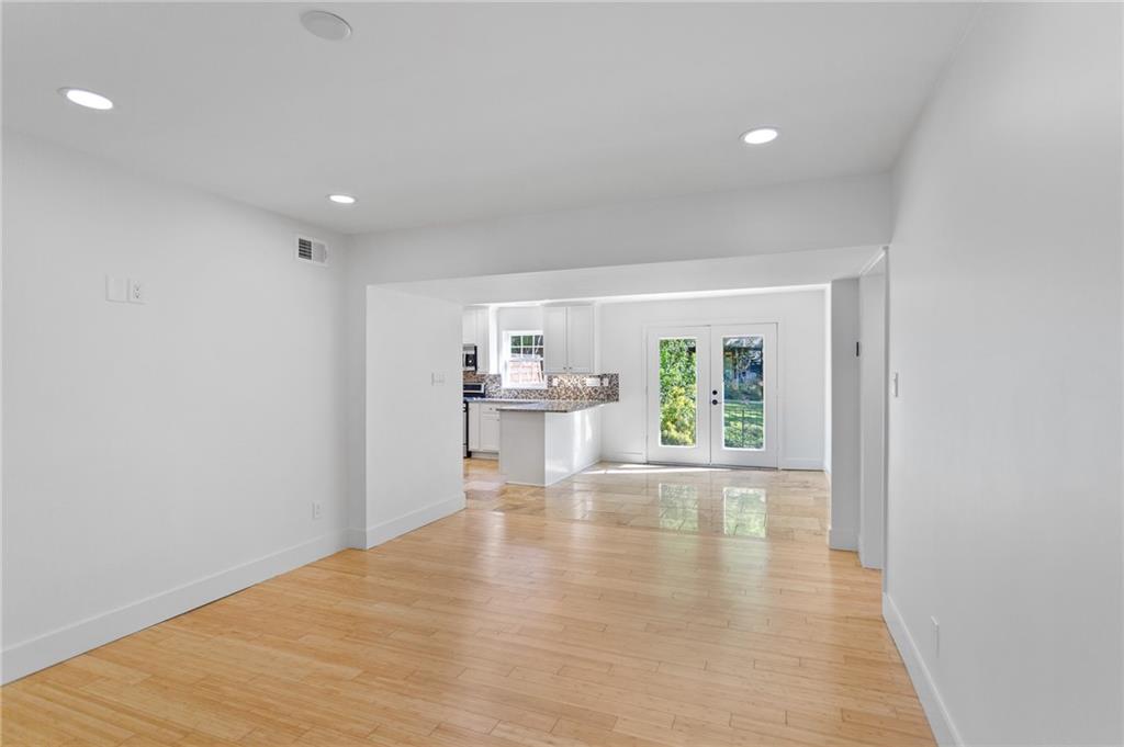 1261 Lavista Road Northeast, Unit C3 Atlanta, GA 30324 - Photo 6 of 34 a view of an empty room with wooden floor and a window