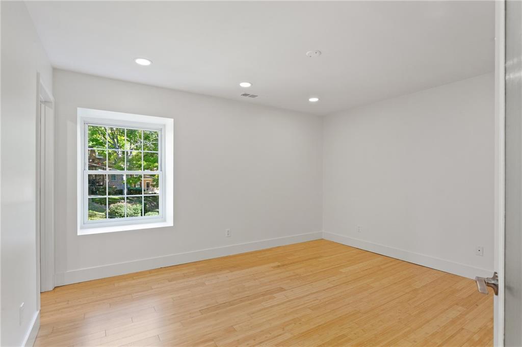 1261 Lavista Road Northeast, Unit C3 Atlanta, GA 30324 - Photo 10 of 34 wooden floor in an empty room with a window