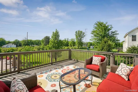 a balcony with furniture and a potted plant