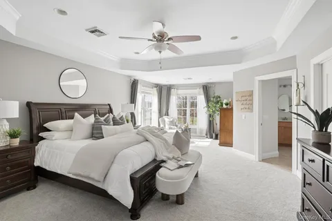 a bedroom with bed and a chandelier