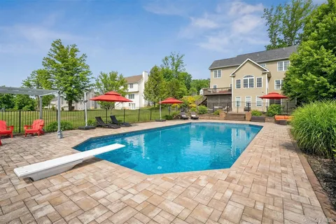 a view of a house with backyard and sitting area