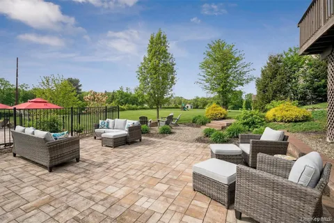 a backyard of a house with barbeque oven table and chairs