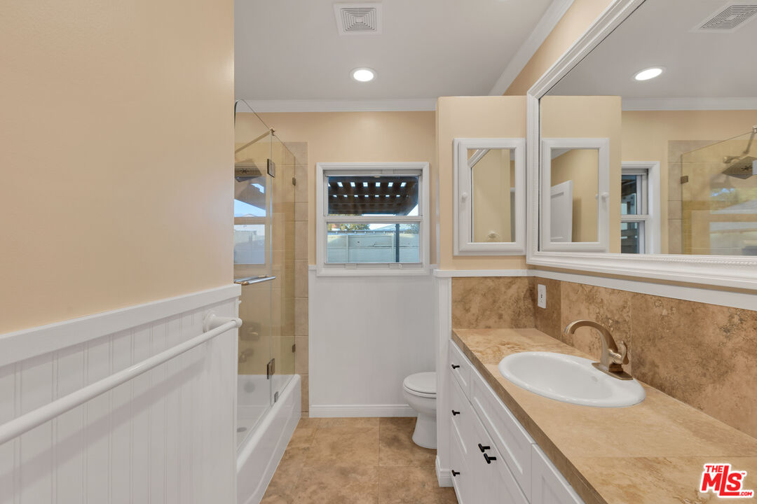 6677 West 88th Street Los Angeles, CA 90045 - Photo 18 of 23 a bathroom with a granite countertop sink mirror vanity and toilet