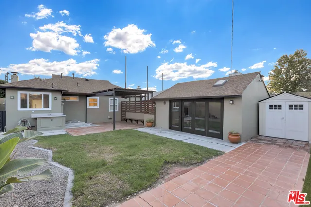 a view of a house with a yard and a patio