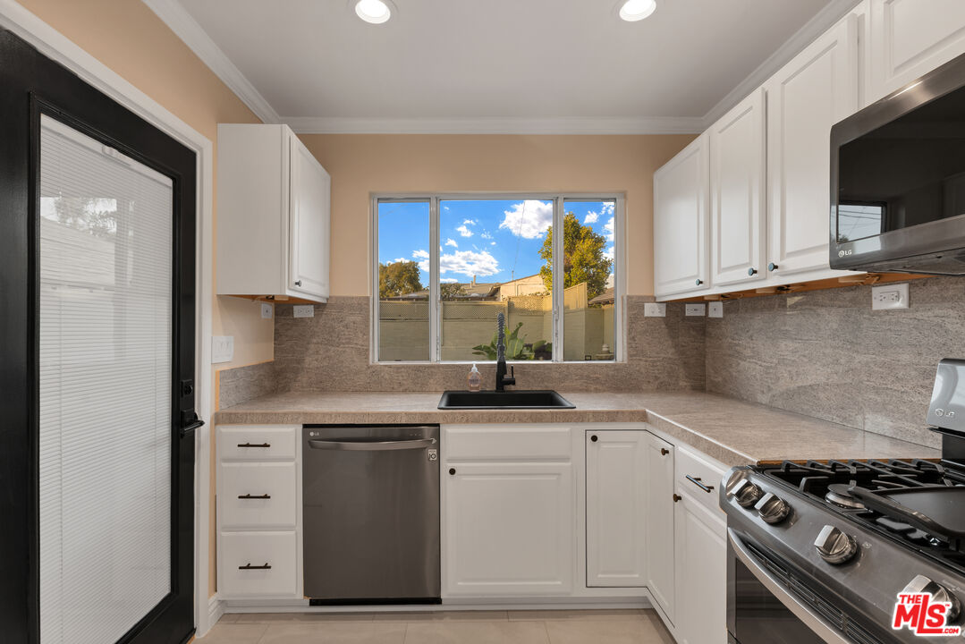 6677 West 88th Street Los Angeles, CA 90045 - Photo 8 of 23 a kitchen with white cabinets and appliances