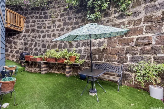 a view of a backyard with a patio and garden