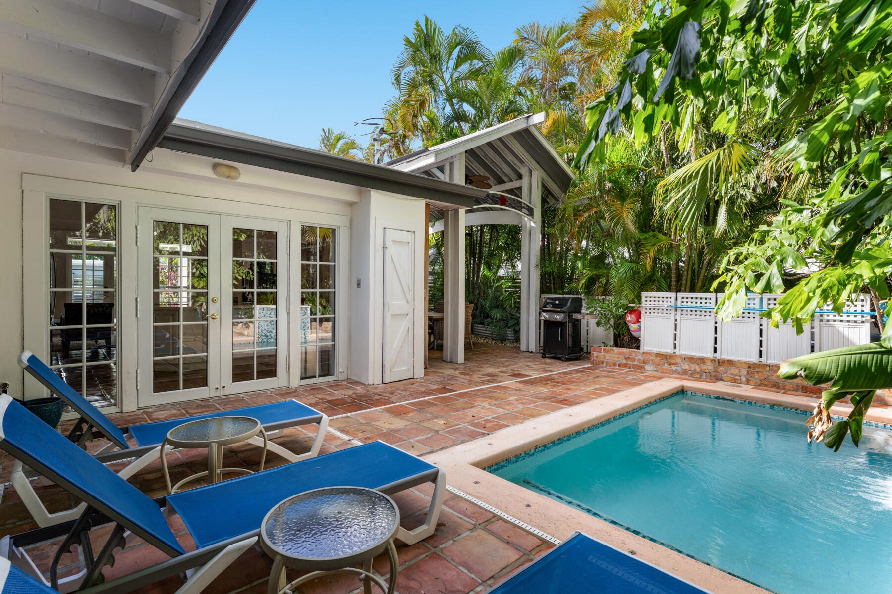 1511 Johnson Street Key West, FL 33040 - Photo 15 of 36 a view of a patio with table and chairs with wooden floor and fence