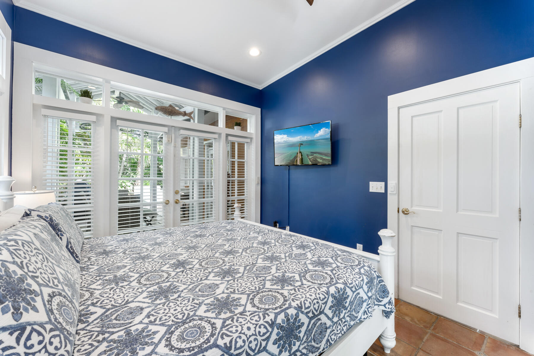 1511 Johnson Street Key West, FL 33040 - Photo 23 of 36 a bedroom with a bed and a large window