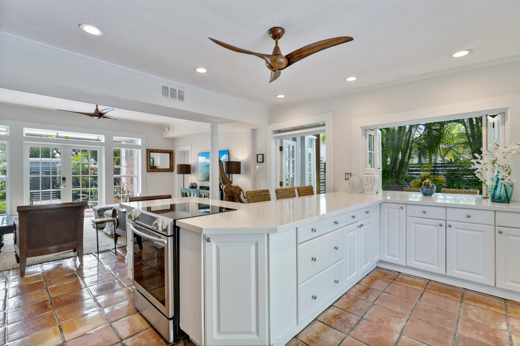 1511 Johnson Street Key West, FL 33040 - Photo 9 of 36 a kitchen with white cabinets and sink