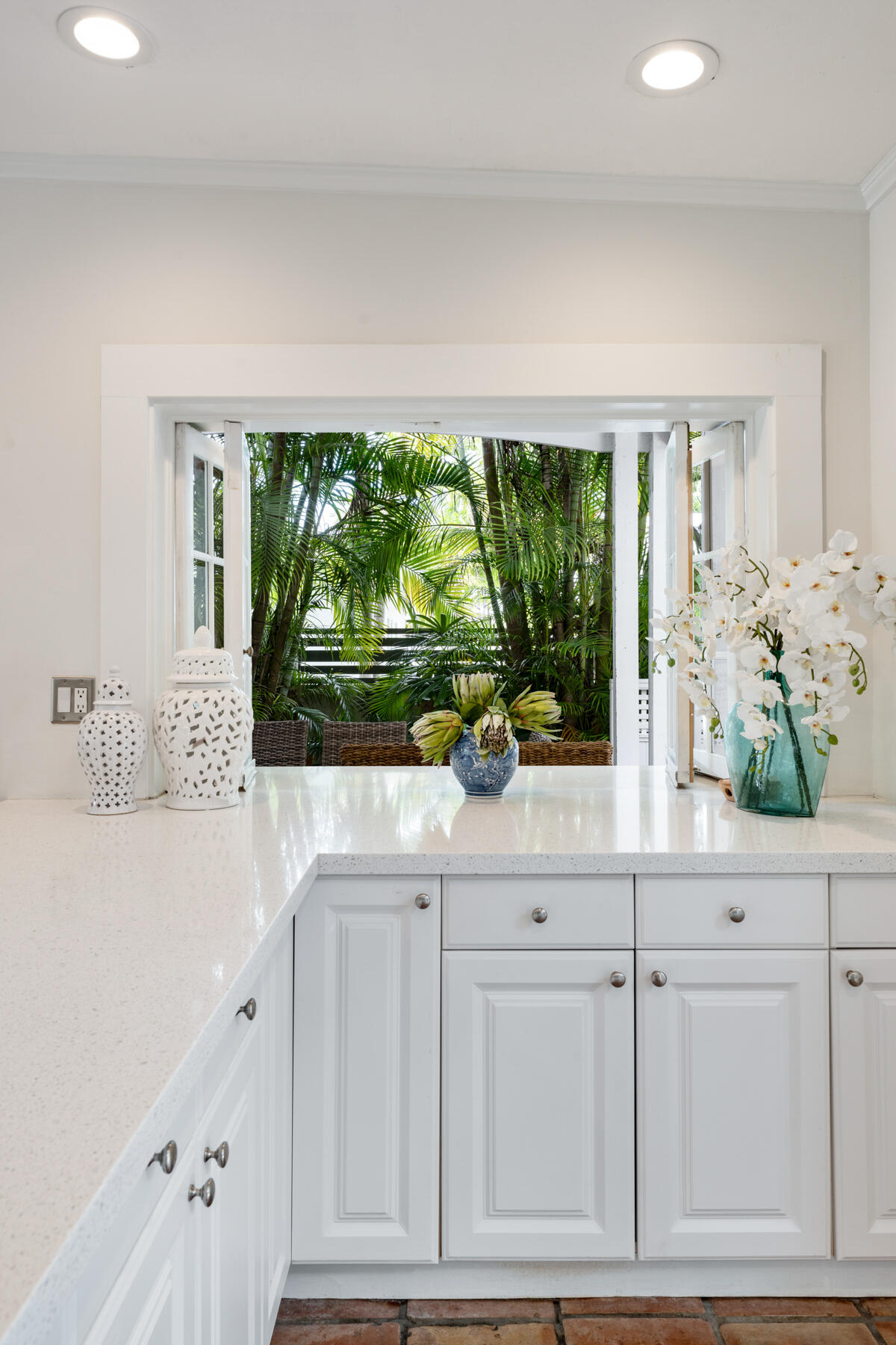 1511 Johnson Street Key West, FL 33040 - Photo 10 of 36 a kitchen with white cabinets and a large window