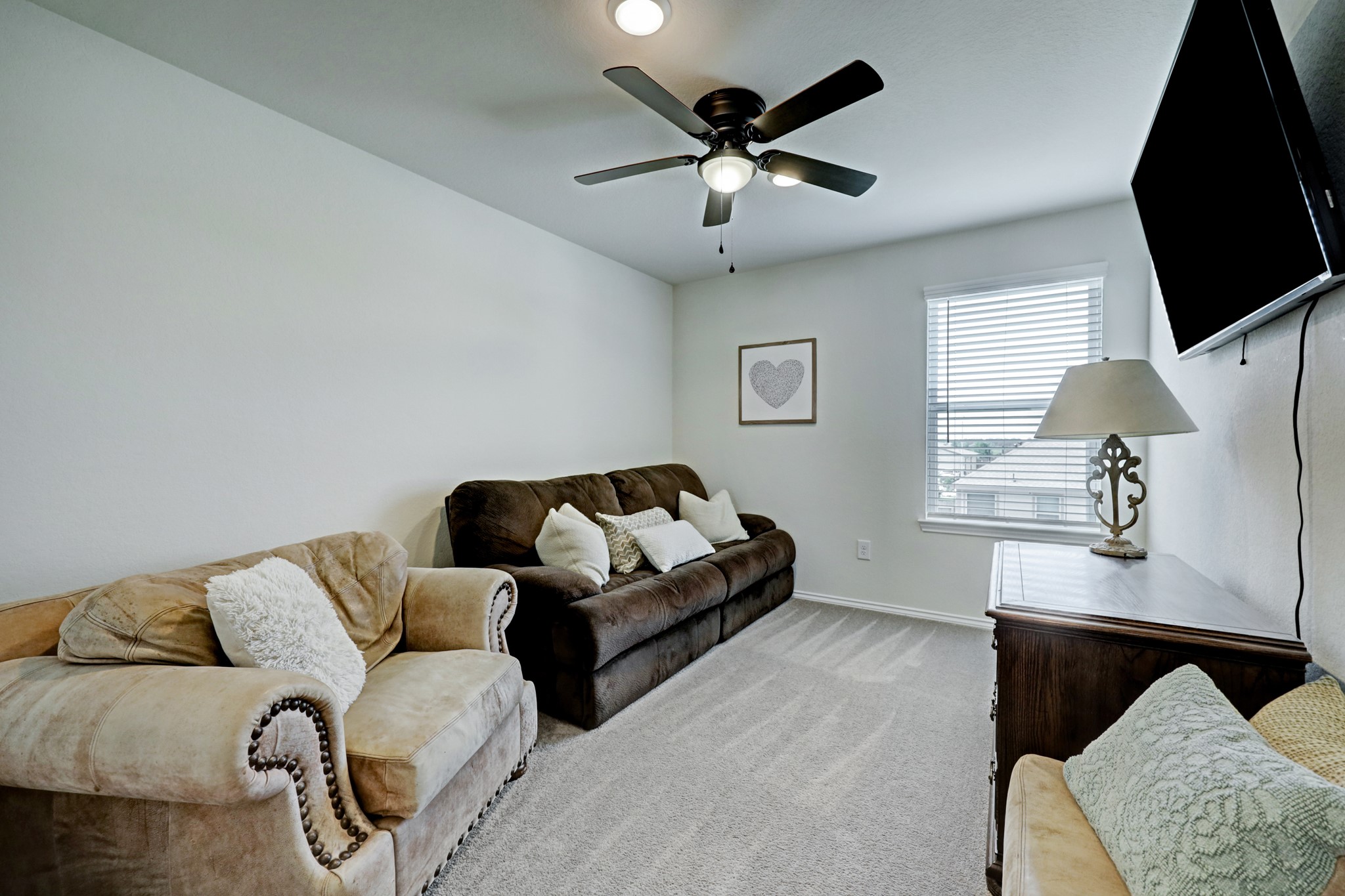 25735 Royal Catchfly Road Katy, TX 77493 - Photo 11 of 31 And second floor game room features plush carpet, large window that allows in natural light, and a ceiling fan.