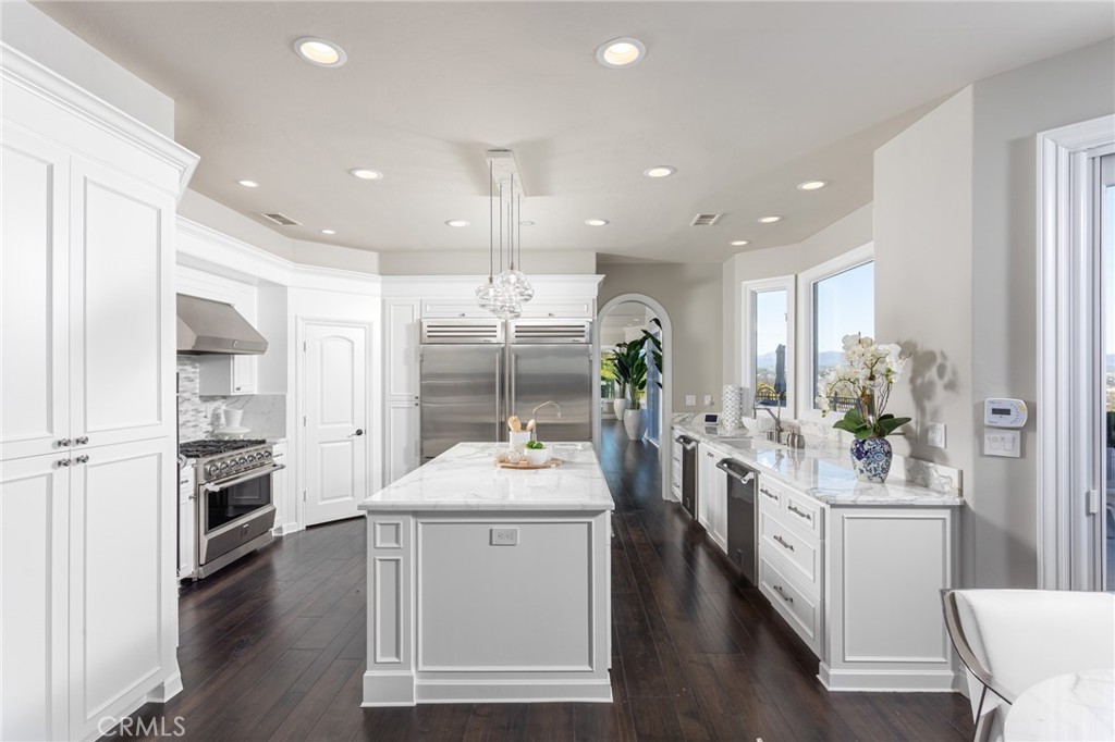 9 Wildflower Laguna Niguel, CA 92677 - Photo 14 of 47 a kitchen with white cabinets and stainless steel appliances