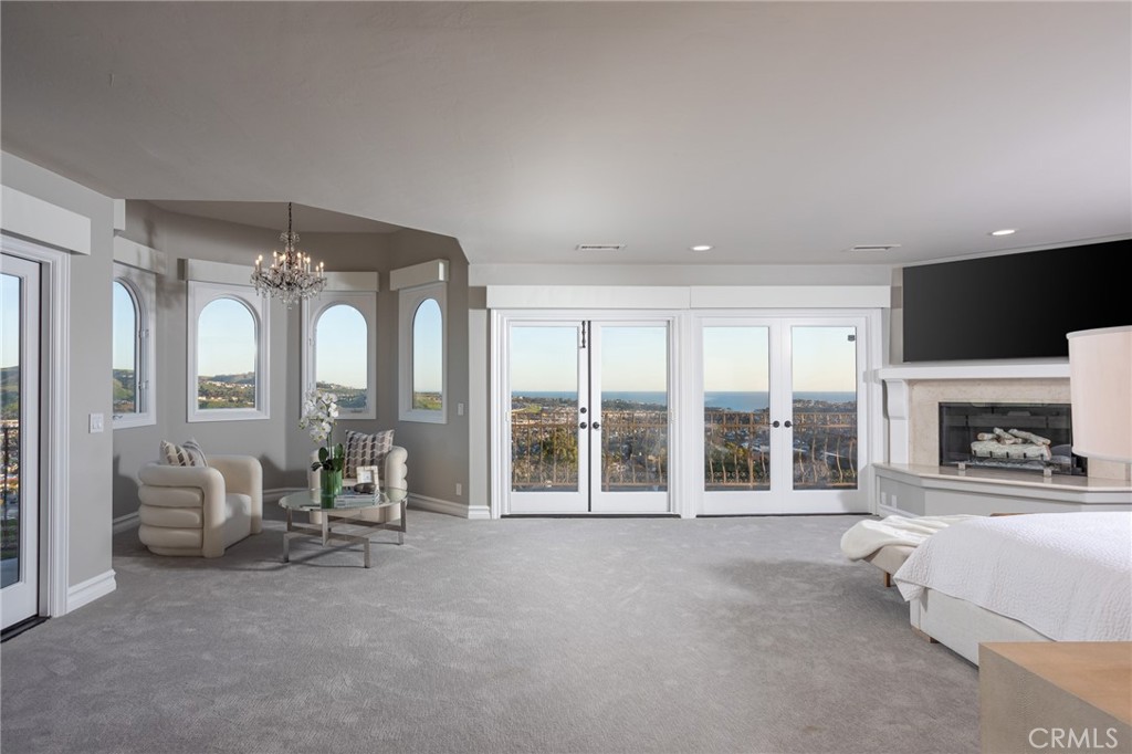 9 Wildflower Laguna Niguel, CA 92677 - Photo 19 of 47 a living room with furniture a fireplace and a flat screen tv