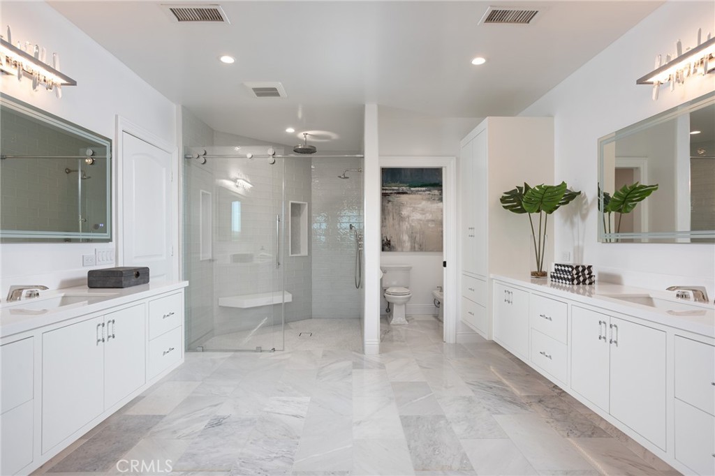 9 Wildflower Laguna Niguel, CA 92677 - Photo 21 of 47 a spacious bathroom with a double vanity sink toilet and shower