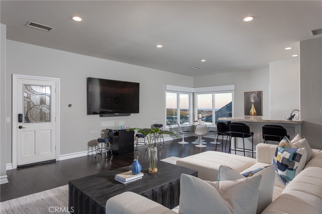 9 Wildflower Laguna Niguel, CA 92677 - Photo 30 of 47 a living room with fireplace furniture and a flat screen tv