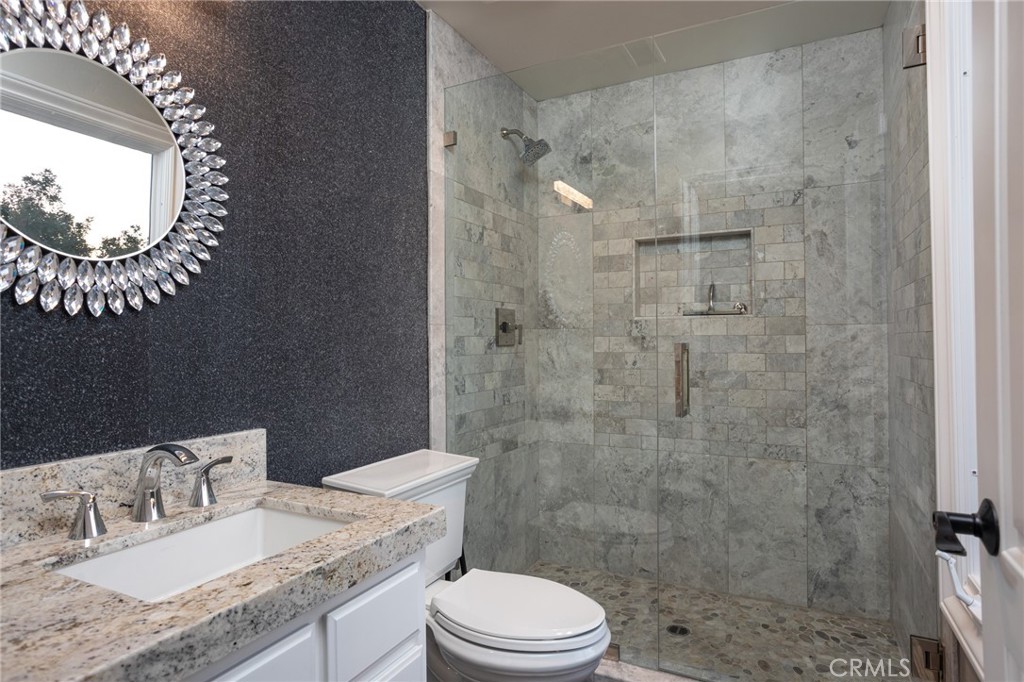 9 Wildflower Laguna Niguel, CA 92677 - Photo 32 of 47 a bathroom with a granite countertop sink a toilet and shower