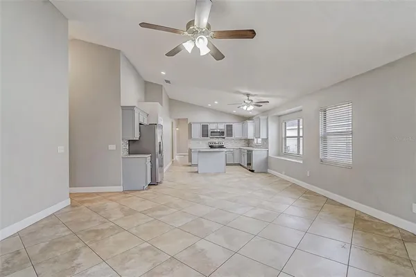 a view of a livingroom with furniture ceiling fan and window