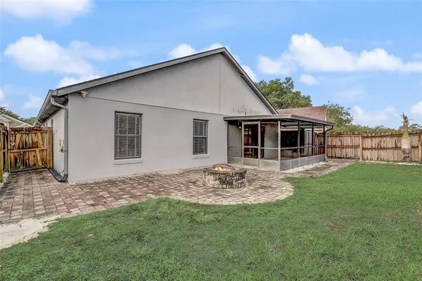 a view of a house with a yard and sitting space