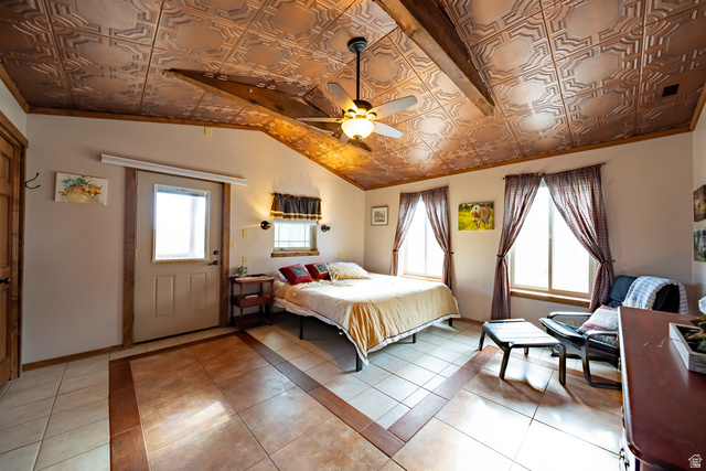 2029 West Tollgate Road Coalville, UT 84017 - Photo 19 of 36 Vaulted ceiling with decorative tin-look panels, exposed wood beams, ceiling fan light fixture, multiple windows, and ceramic tile flooring with a wood-look border