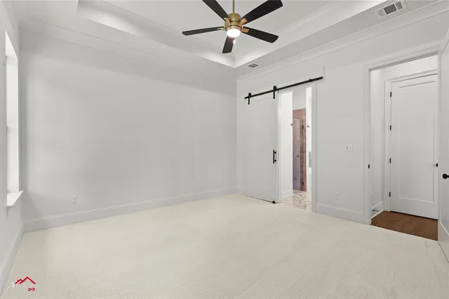 a view of a room with a ceiling fan and a window