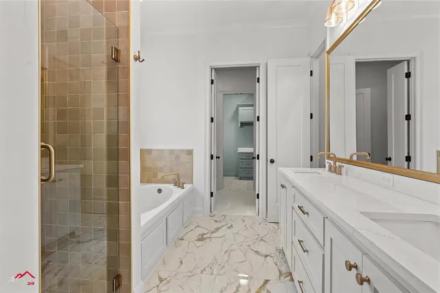 a bathroom with a tub sink and mirror