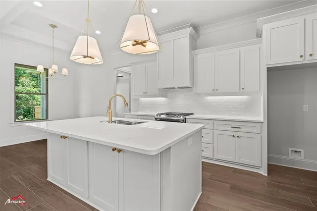 a kitchen with a sink cabinets and window
