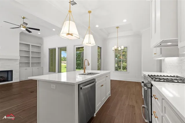 a kitchen with a stove and a wooden floor