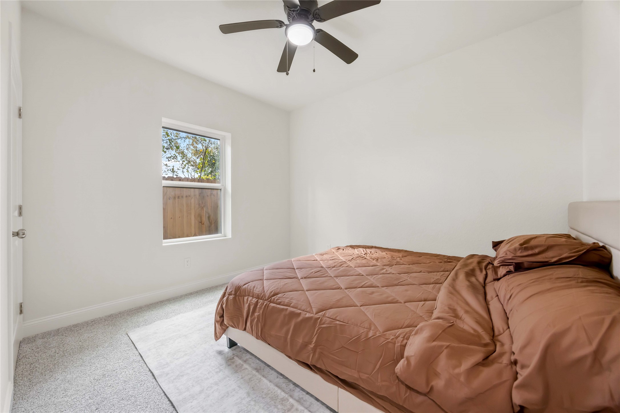 9129 Brandon Street, Unit B1 Houston, TX 77051 - Photo 13 of 15 a bedroom with a bed and a window