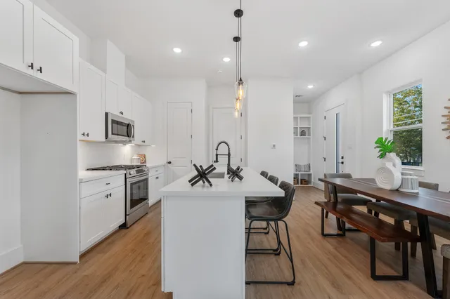 a kitchen with stainless steel appliances kitchen island granite countertop a sink and cabinets
