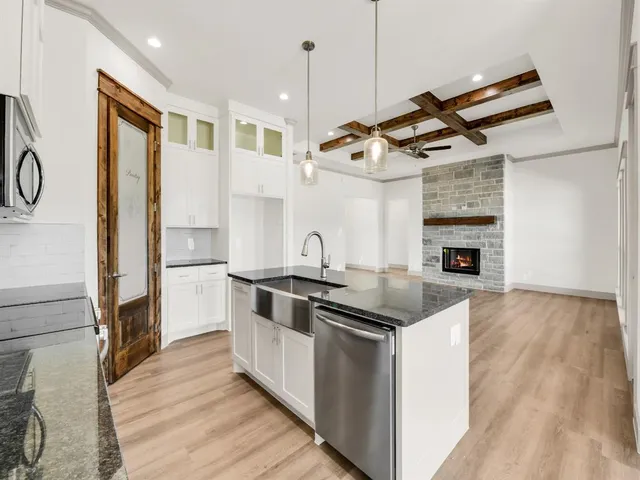 a kitchen with stainless steel appliances granite countertop a stove and a sink