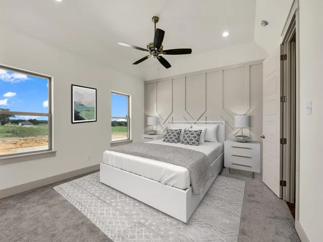 a spacious bedroom with a large bed and a chandelier